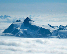 A view from Mt. Baker of Mt. Shuksan and the Sulphide glacier peeking through the dense clouds