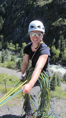 AAI Guide Erin Smart smiles at a belay station in Leavenworth.