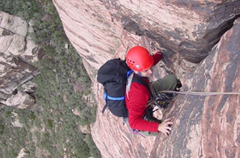 A climber pulls through a roof on Mr. Z (5.7, III). This moderate six-pitch line was established in 2003