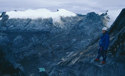 A climbers takes pause to enjoy the view on the ascent of Carstensz Pyramid.