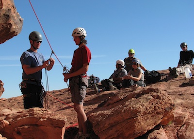 AAI Guide Jason Martin instructing a group of SPI Candidates on rock rescue techniques in Red Rock, Nevada.