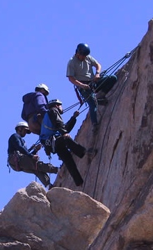 A climber works a high-end rescue scenario with multiple patients.