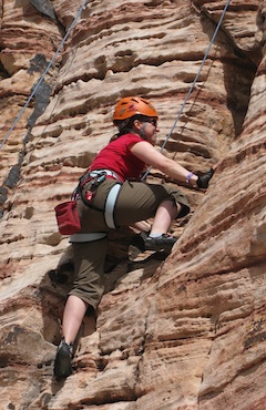 A beginner climber works on movement skills while on top-rope in Red Rock